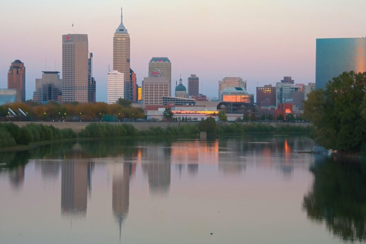 A city skyline next to the water, which reflects the buildings
