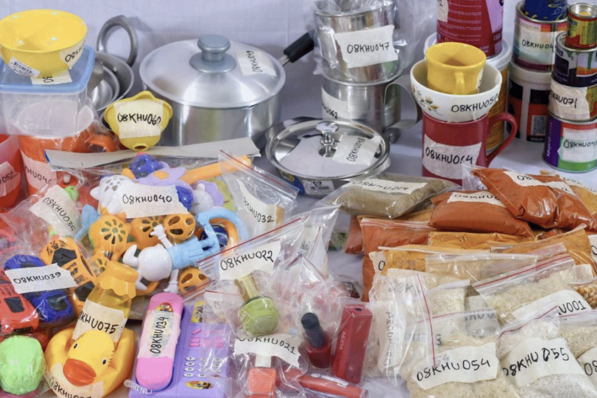 Plastic items, food, and dishware sit on a counter in labeled bags